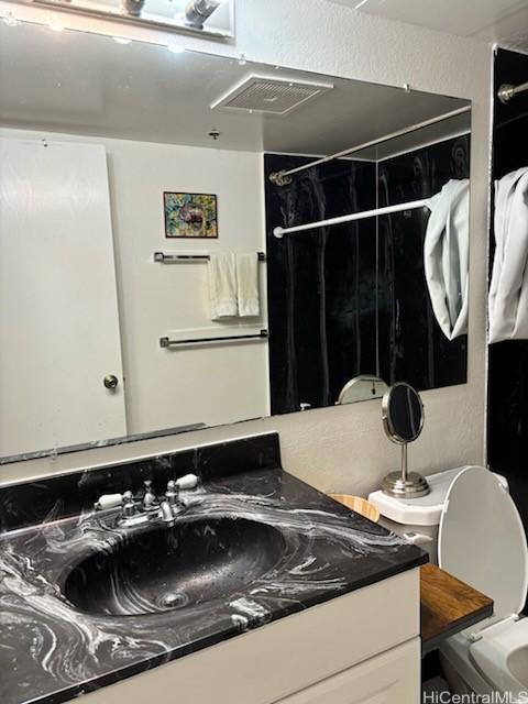 bathroom with vanity and toilet