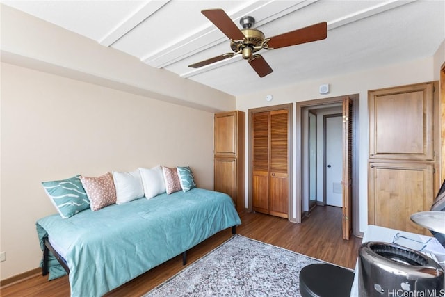 bedroom featuring dark wood-type flooring and ceiling fan