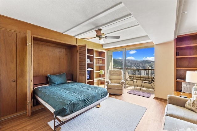 bedroom featuring ceiling fan, access to exterior, and light wood-type flooring