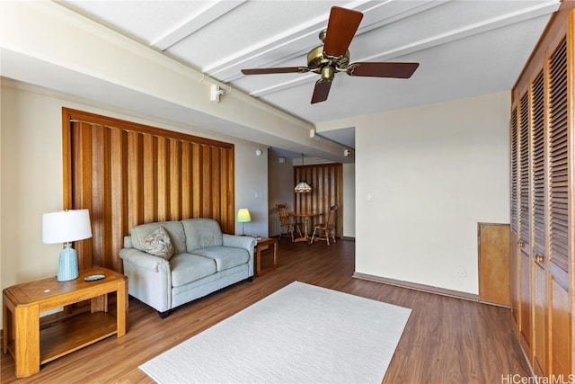 living room featuring dark hardwood / wood-style floors and ceiling fan