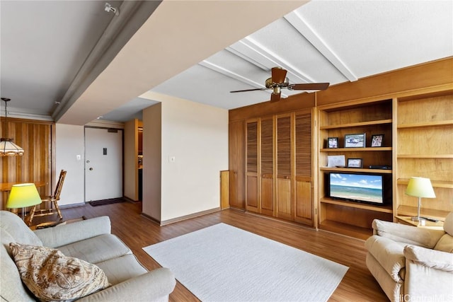 living room featuring hardwood / wood-style floors and ceiling fan