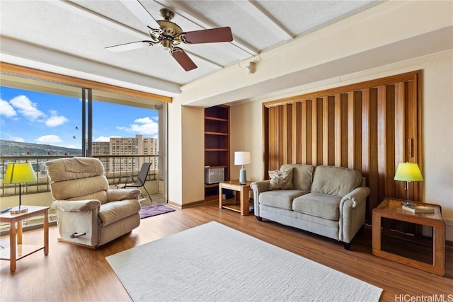 living room featuring hardwood / wood-style flooring and ceiling fan