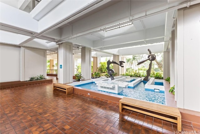 view of swimming pool with a hot tub