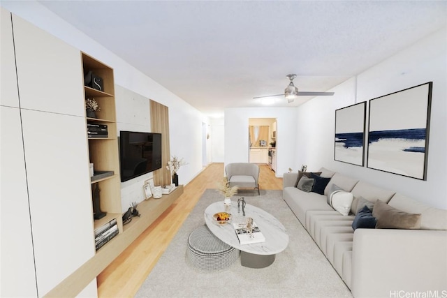 living room featuring ceiling fan and light hardwood / wood-style flooring