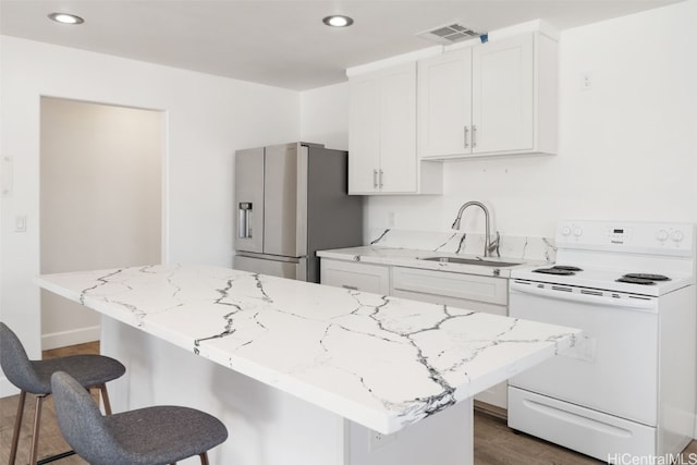 kitchen featuring a kitchen island, white cabinetry, sink, electric range, and stainless steel fridge with ice dispenser