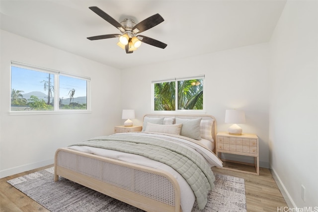 bedroom with ceiling fan and light wood-type flooring