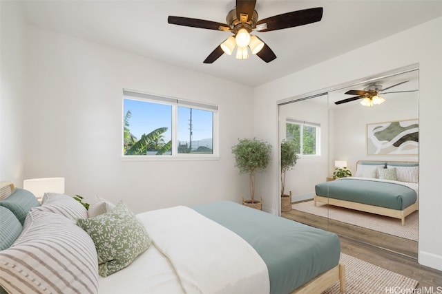 bedroom featuring hardwood / wood-style floors, ceiling fan, and a closet