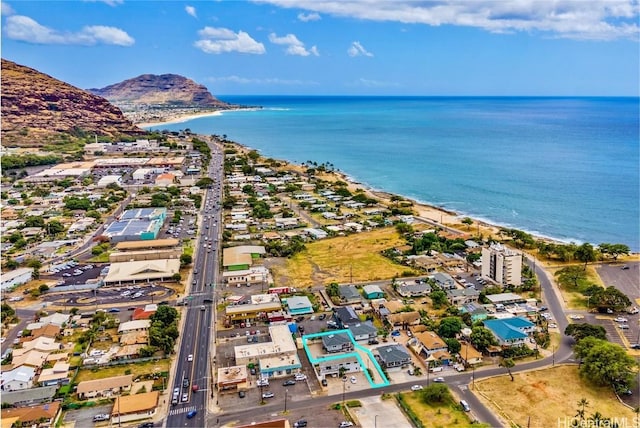 drone / aerial view featuring a water and mountain view