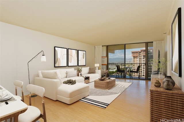 living room with wood finished floors and floor to ceiling windows