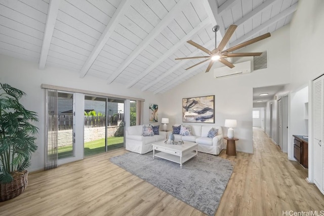 living room featuring beam ceiling, a wall mounted AC, and light wood-type flooring