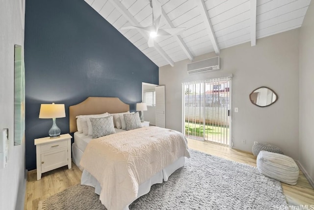 bedroom featuring light hardwood / wood-style flooring, a wall mounted air conditioner, access to outside, and lofted ceiling with beams