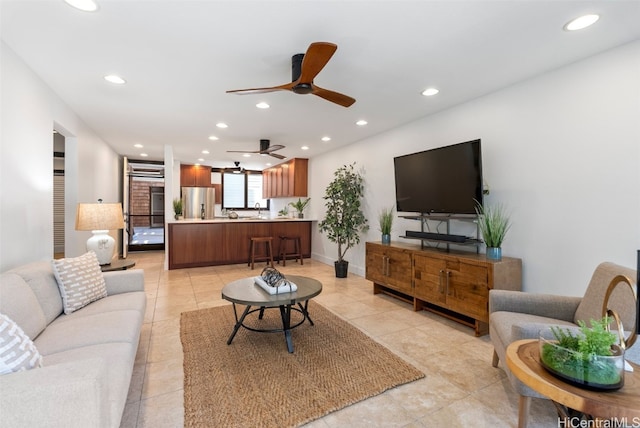 living area with light tile patterned floors, recessed lighting, baseboards, and ceiling fan