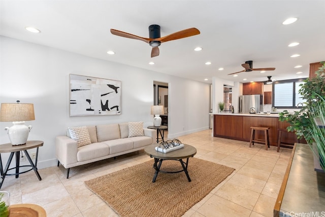 living room featuring light tile patterned flooring, recessed lighting, and baseboards