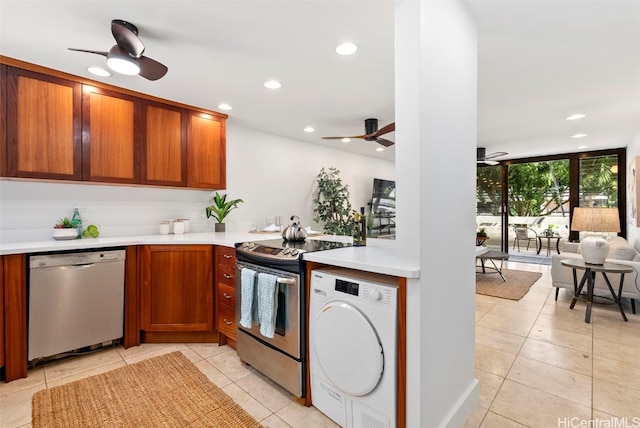 kitchen with light countertops, washer / clothes dryer, a ceiling fan, and appliances with stainless steel finishes