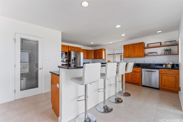3515 Upper St, Honolulu, HI 96815 - kitchen featuring dark countertops, open shelves, brown cabinetry, and stainless steel appliances