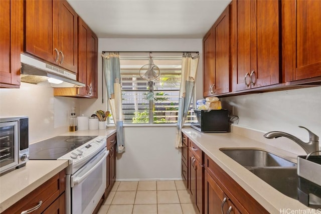 kitchen featuring sink, light tile patterned floors, and white range with electric cooktop