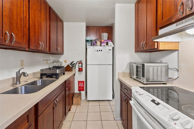 kitchen with sink, light tile patterned floors, and white appliances