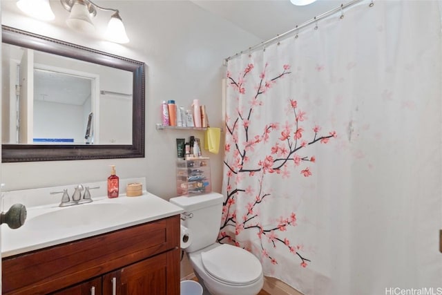 bathroom with vanity, a shower with curtain, and toilet