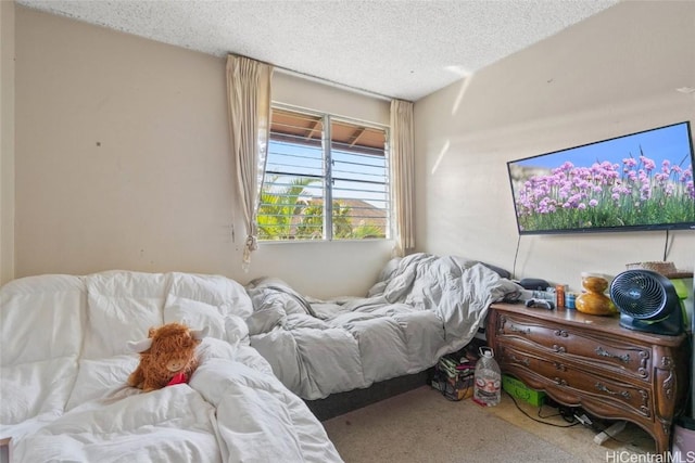 bedroom with carpet and a textured ceiling