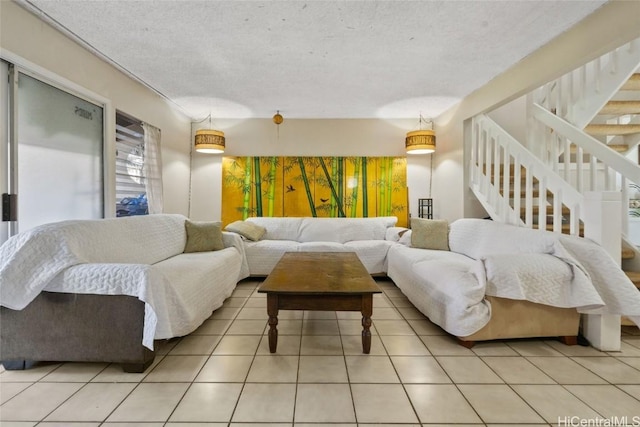 tiled living room featuring a textured ceiling