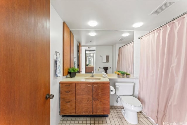 bathroom with vanity, tile patterned floors, and toilet