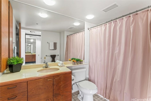 bathroom with vanity, curtained shower, tile patterned floors, and toilet