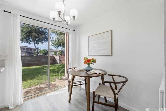 dining area featuring hardwood / wood-style floors and a chandelier