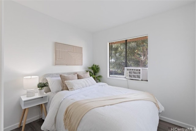 bedroom featuring cooling unit and dark hardwood / wood-style flooring