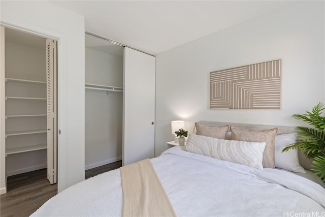 bedroom featuring dark hardwood / wood-style flooring and a closet