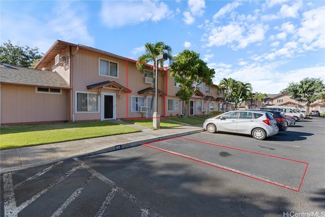 view of parking with a yard