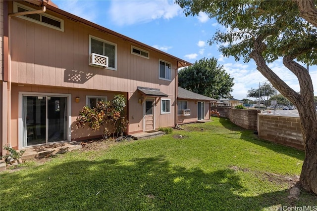 rear view of property with a yard