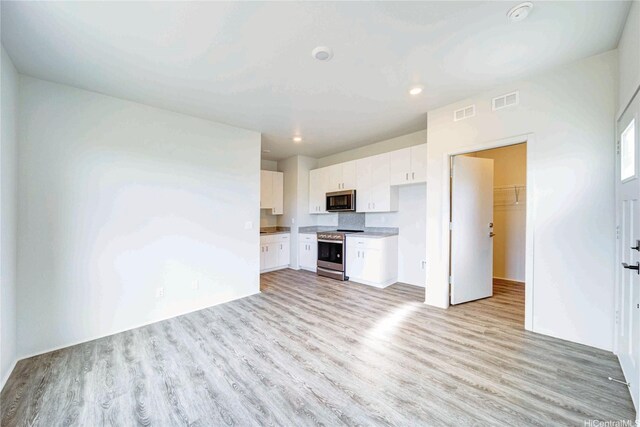 kitchen featuring light wood-style floors, white cabinetry, visible vents, and appliances with stainless steel finishes