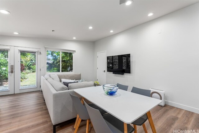 dining room with light wood-type flooring and french doors