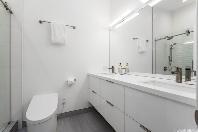 bathroom featuring vanity, an enclosed shower, and toilet