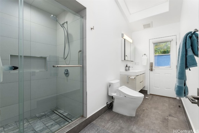 bathroom with vanity, toilet, and a shower with door