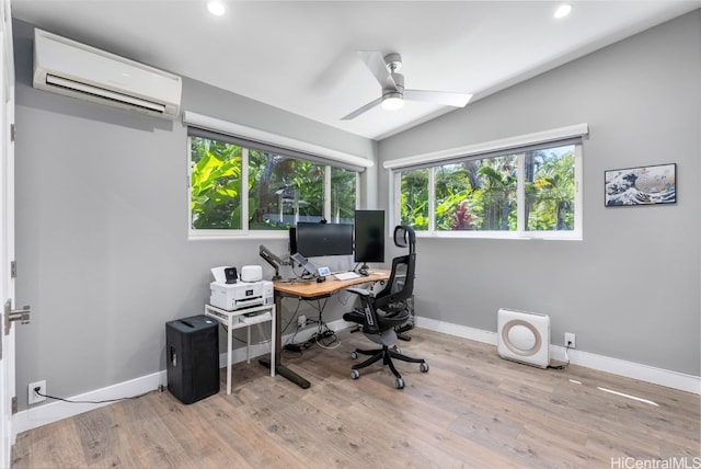 office area with ceiling fan, lofted ceiling, a wall mounted air conditioner, and light hardwood / wood-style floors