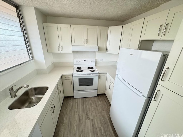 kitchen featuring sink, a textured ceiling, dark hardwood / wood-style flooring, white appliances, and white cabinets