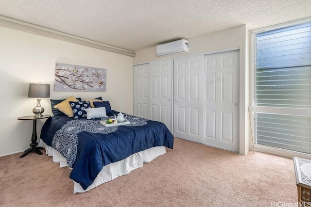 bedroom with carpet, a textured ceiling, a wall unit AC, and a closet