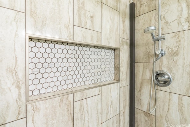 interior details with a tile shower