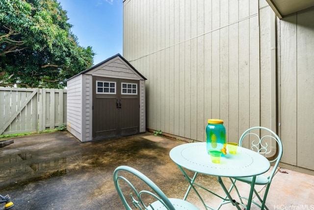 view of shed featuring fence