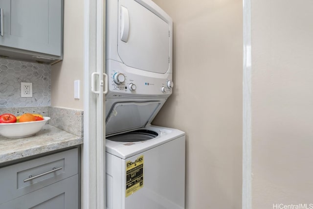 washroom with laundry area and stacked washer / drying machine