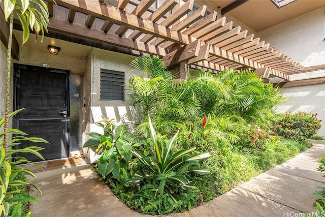 entrance to property featuring a pergola