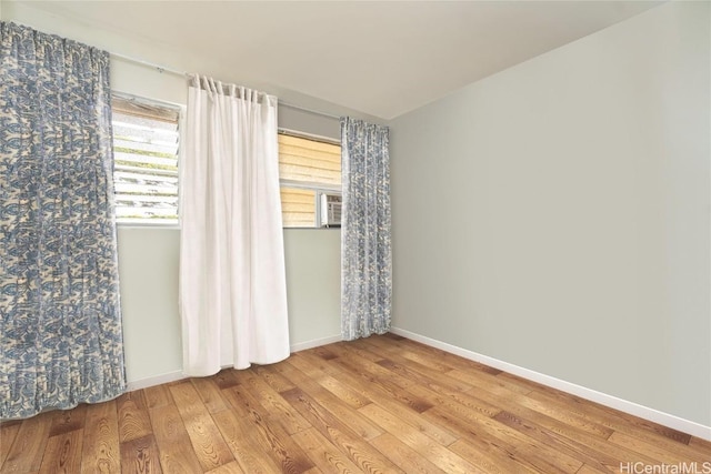 spare room featuring wood-type flooring and cooling unit