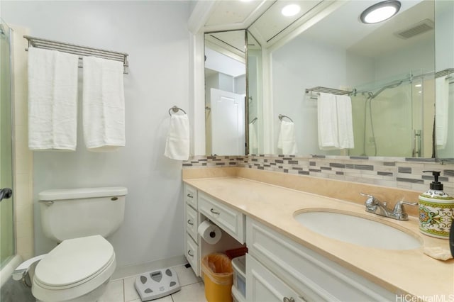 bathroom with vanity, decorative backsplash, a shower with shower door, tile patterned floors, and toilet