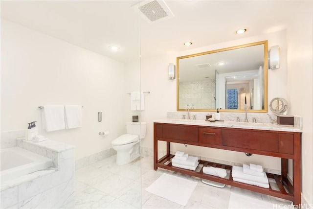 bathroom featuring toilet, a garden tub, visible vents, and a sink