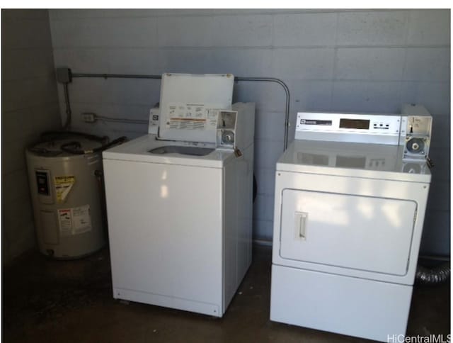 clothes washing area with water heater and independent washer and dryer