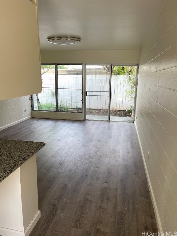 interior space featuring a healthy amount of sunlight and dark hardwood / wood-style flooring