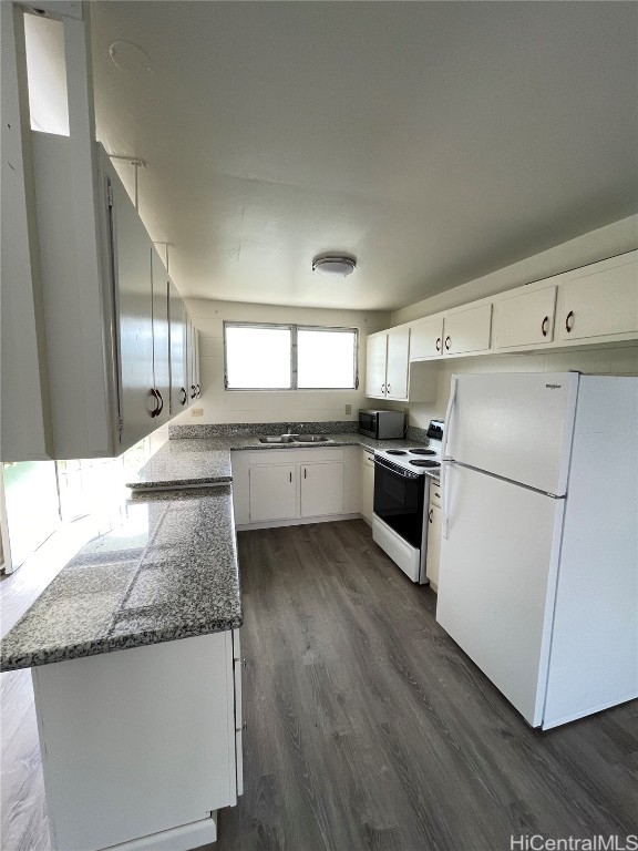 kitchen featuring white cabinetry, sink, white appliances, and dark hardwood / wood-style flooring