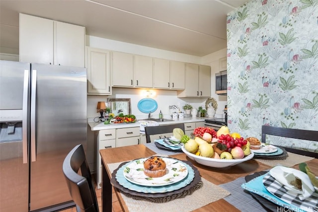 kitchen featuring light countertops, appliances with stainless steel finishes, and a sink