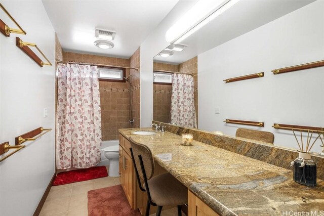 full bathroom with vanity, tile patterned floors, toilet, and shower / bath combo with shower curtain